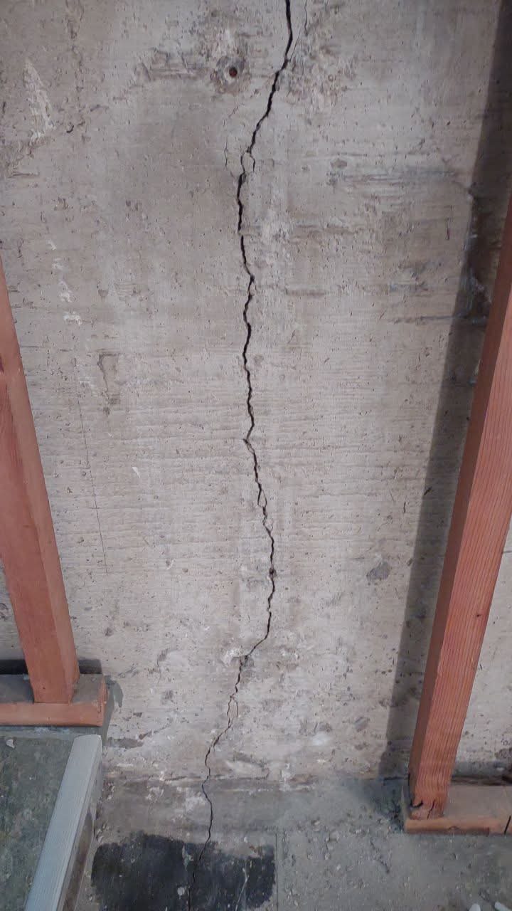 Vertical crack running full height of poured concrete foundation wall — common in Chicago-area homes