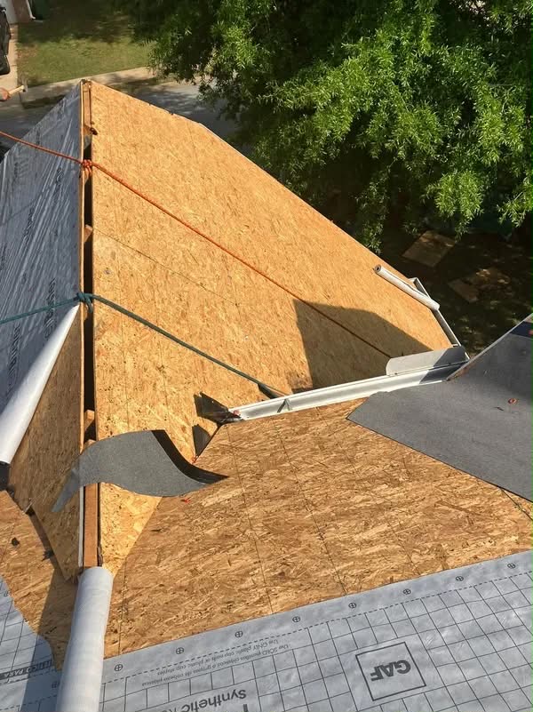 New OSB roof deck sheathing installation on residential home — aerial view showing full replacement